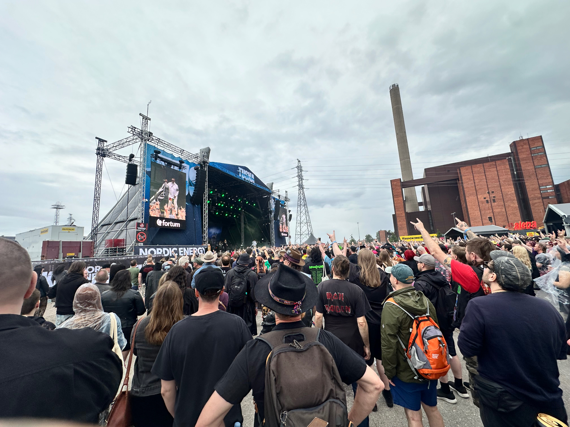 Skindred performing at Tuska Festival 2026 with the crowd throwing horns under cloudy Helsinki skies