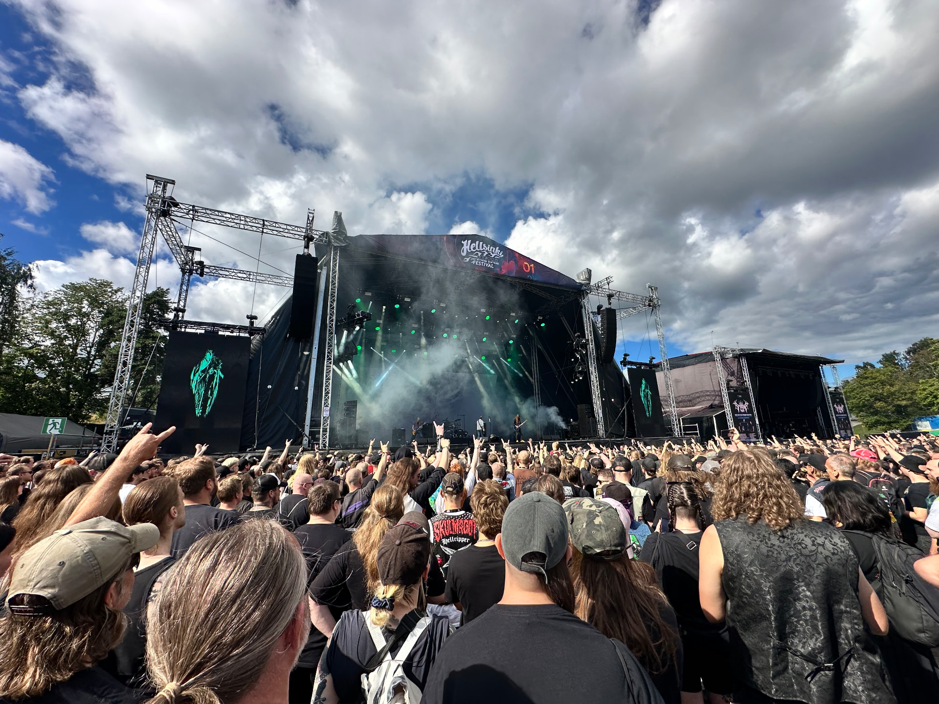 Carcass performing at Hellsinki Metal Festival 2026 under green lights with horns raised across the crowd