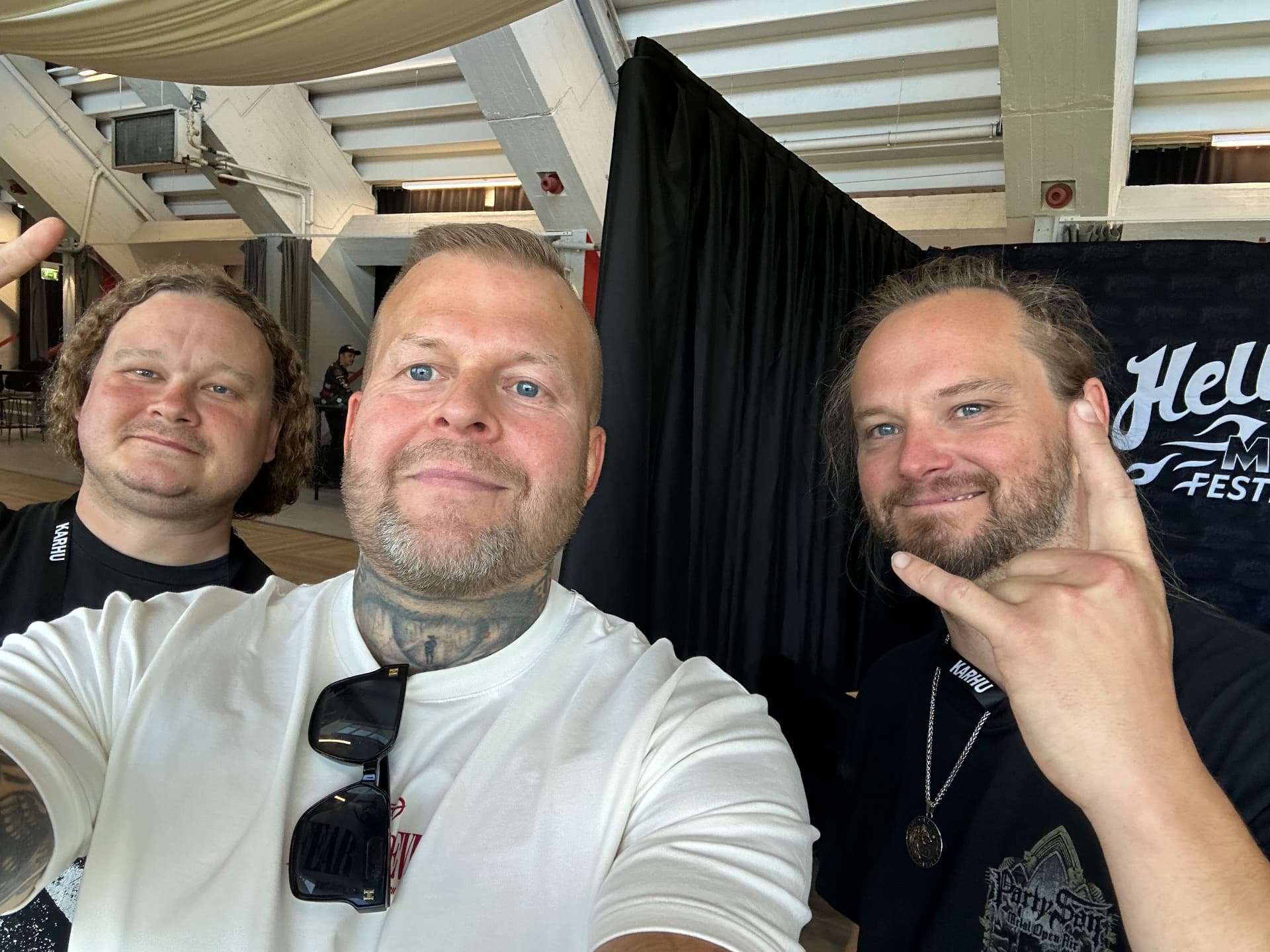 Tomi Perrakoski backstage with Iotunn's drummer at Hellsinki Metal Festival 2026 in front of the festival backdrop