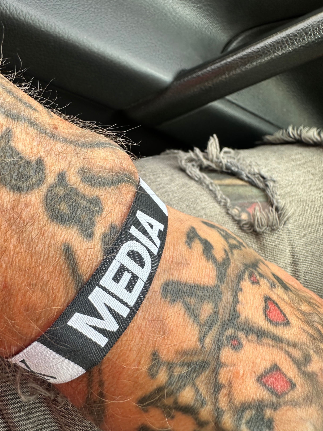 Metal Madness Weekly media wristband on tattooed arm — Ruisrock 2026
