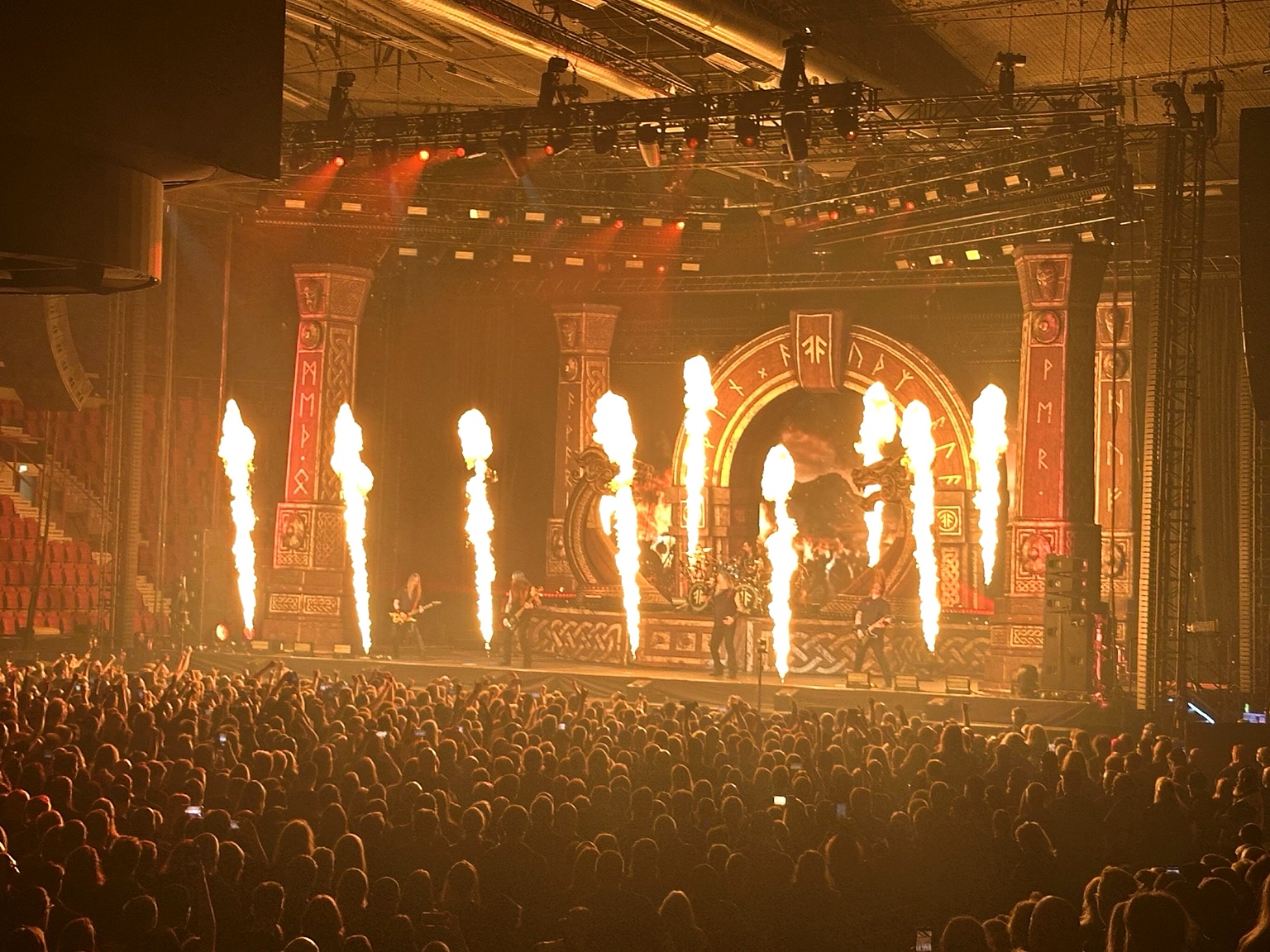 Amon Amarth performing live in Helsinki with towering columns of flame across the stage, 26 October 2026.